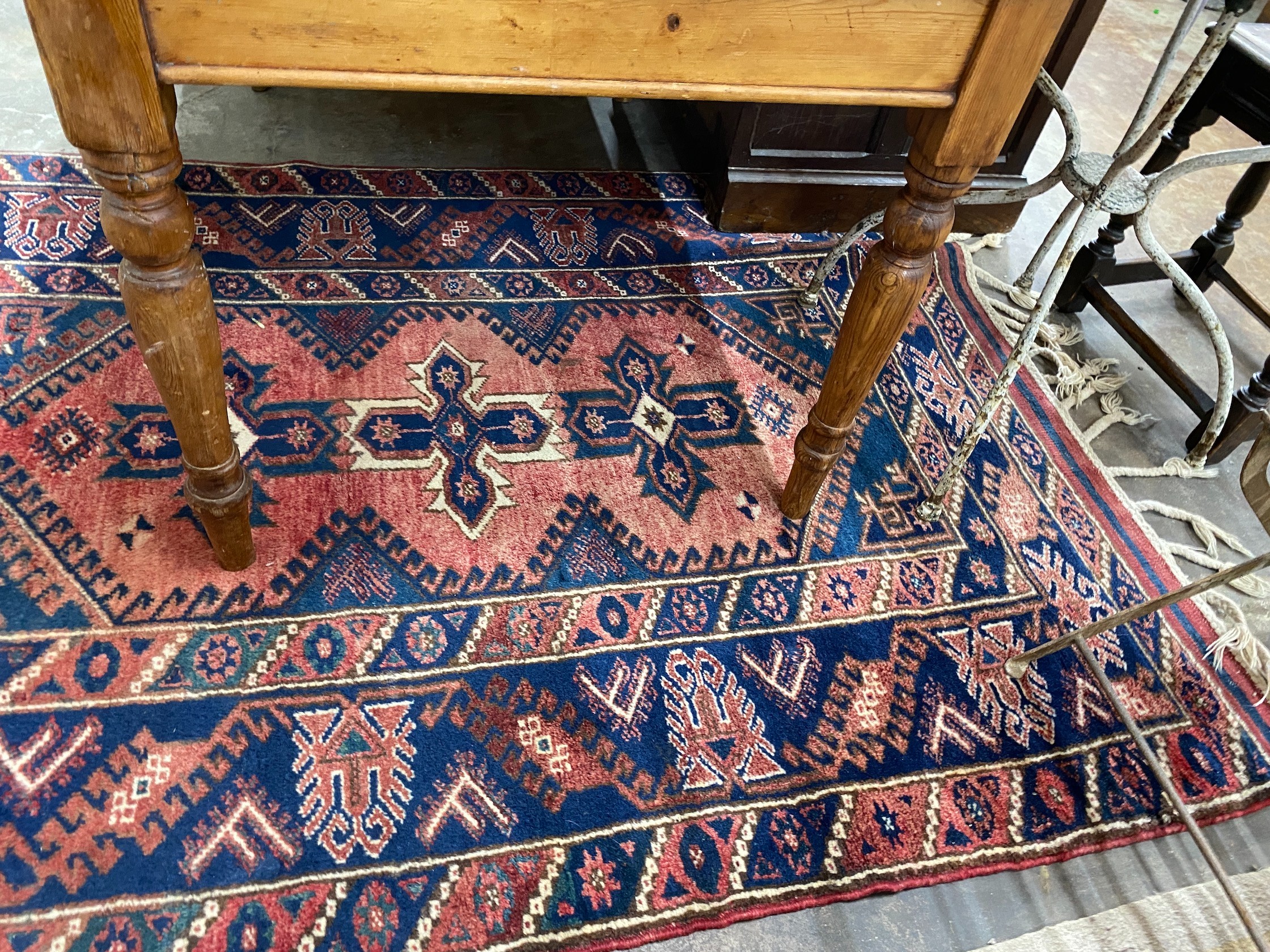 A Caucasian style red ground rug, 184 x 130cm